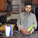 Aqua-8 Water Ozone Generator with a man soaking vegetables in ozonated water