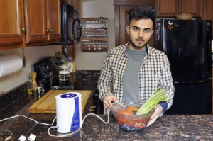 Aqua-8 Water Ozone Generator with a man soaking vegetables in ozonated water