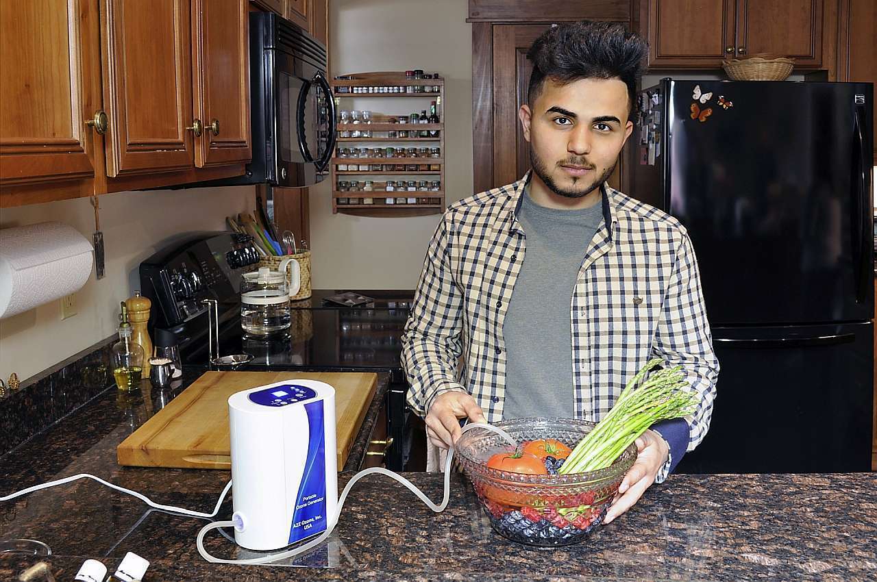 Aqua-8 Water Ozone Generator with a man soaking vegetables in ozonated water